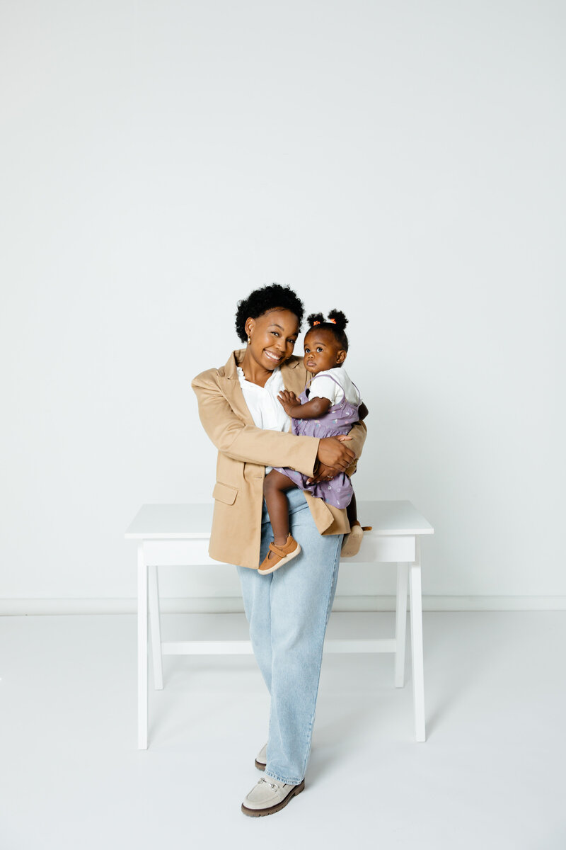 Women standing  holding  a young girl
