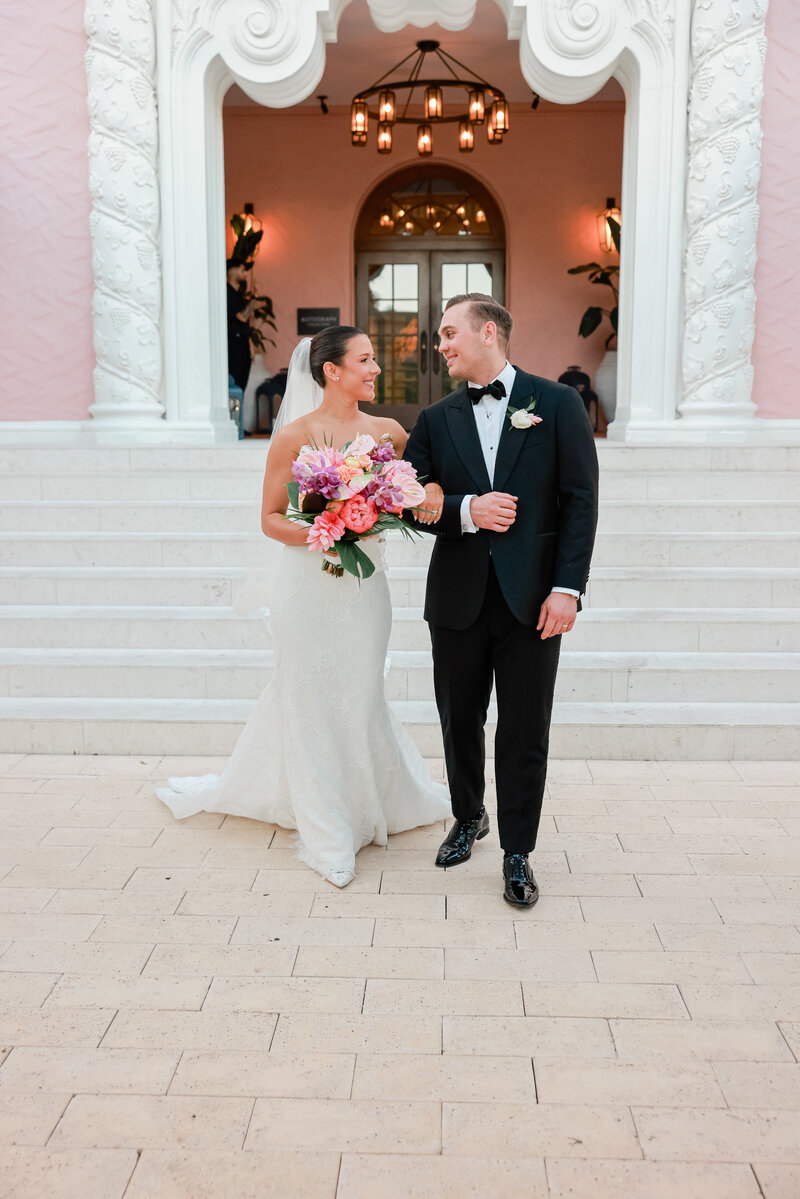 a bride and groom smiling at each other