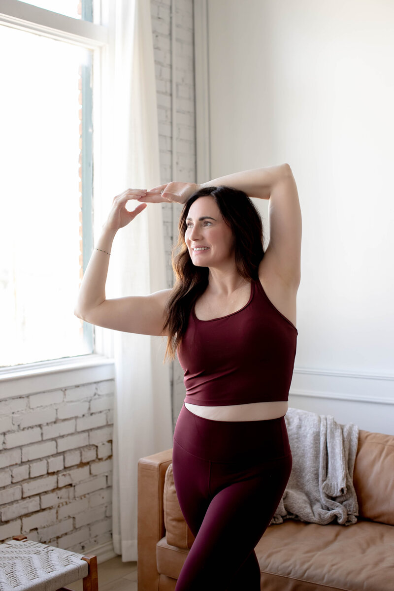 About Trish: Relaxed and happy holistic coach looking out a window