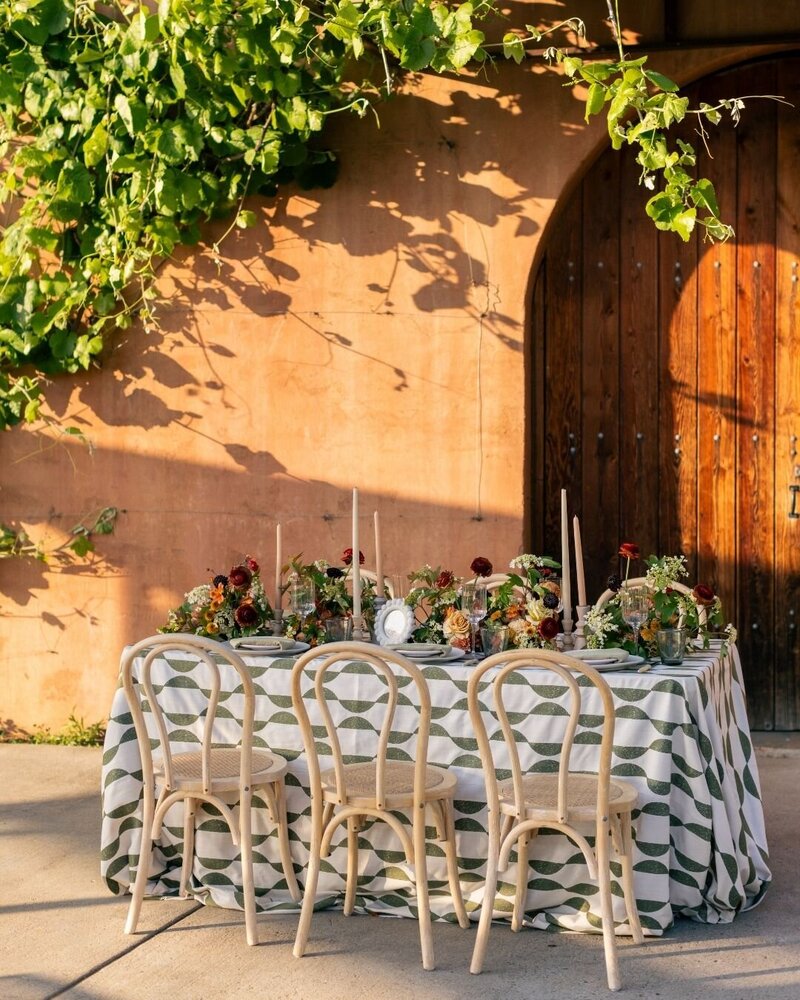 Elegant low centerpiece with lush greenery by Kendra’s Events in Granbury.