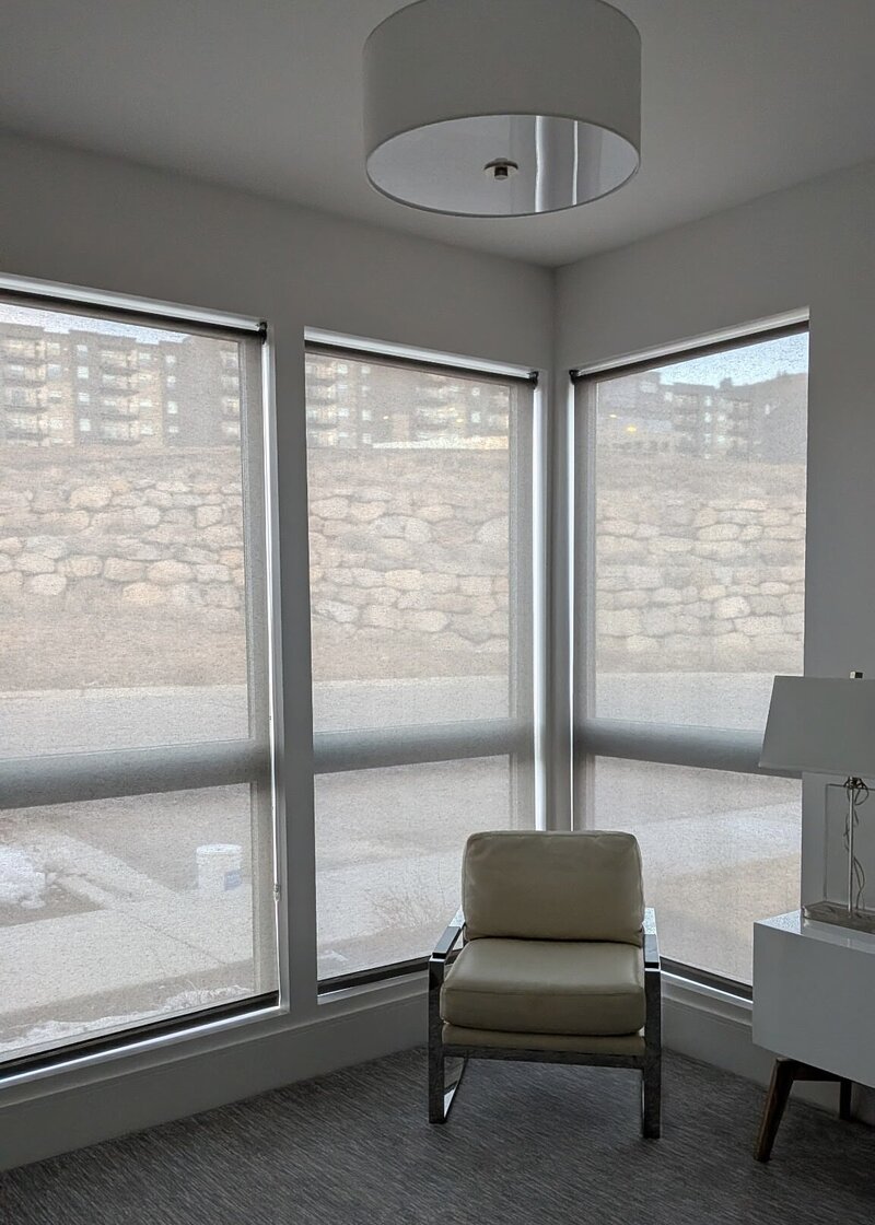 Solar shades on corner windows in a sitting area of a Park City, Utah live/work property