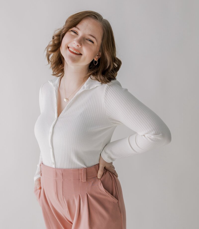 A Richmond maternity photographer smiles happily at the camera.