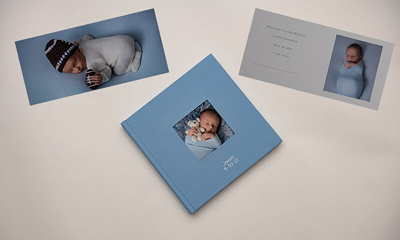 Three fine art albums lay on a table