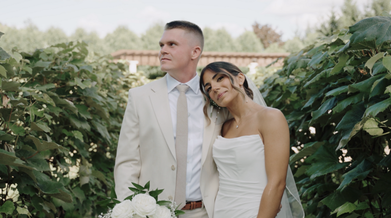 Couple Walking Down A Lawn Holding Hand-in-Hand