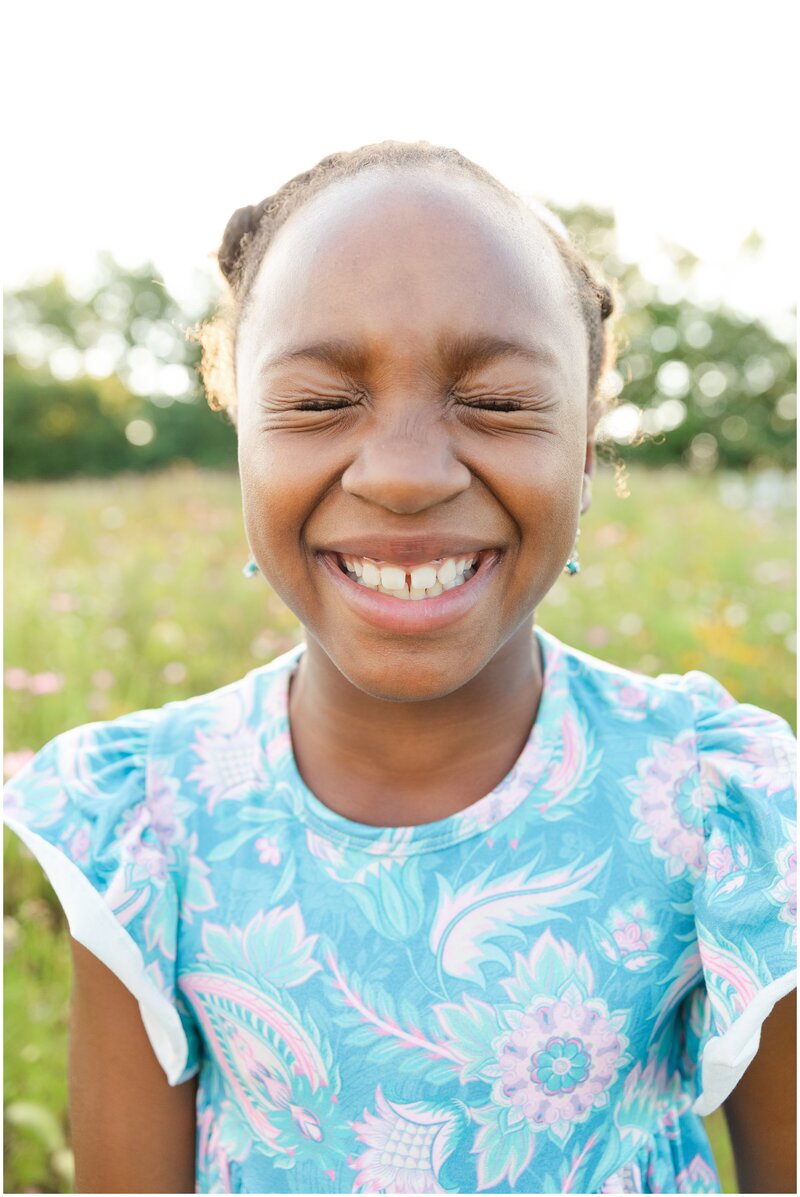 A girl laughing during a family photo session in Georgetown KY.