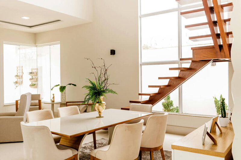 Clean dining room with wooden staircase