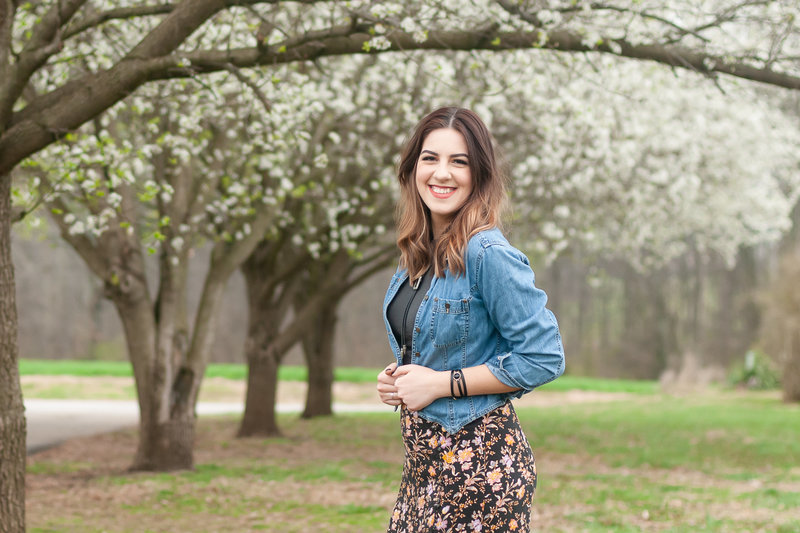 Bowling Green KY Photographer: Portrait of Rajna in front of budding Dogwood trees.