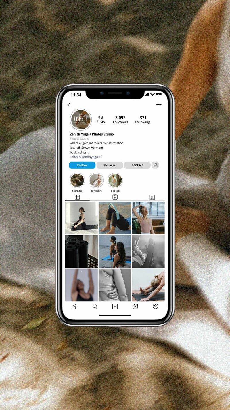 At Zenith Yoga and Pilates Studio, a woman sits on the floor, engaged with her phone, radiating calmness.