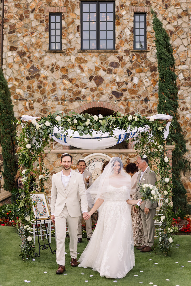 bride and groom dancing as they exit wedding ceremony at bella collina