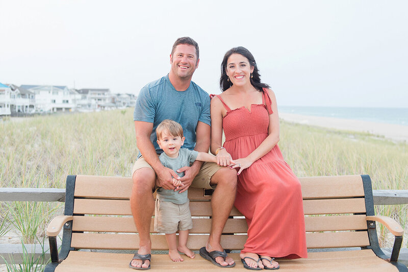 Family sitting onn beach bench in Lavallette, NJ