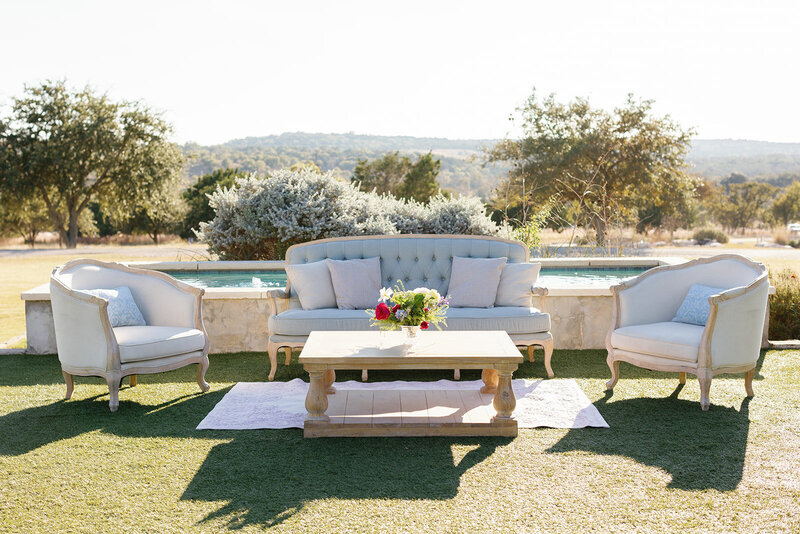 Vintage lounge in front of a fountain with a hill country background