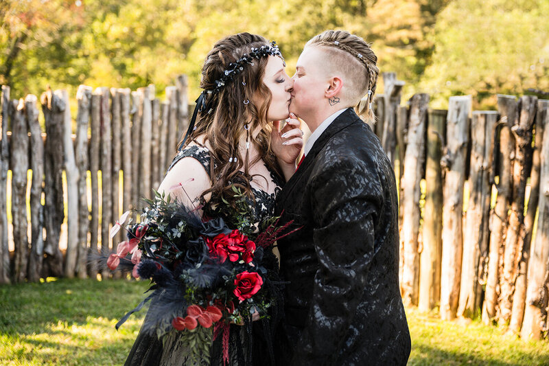 A lesbian couple kiss one another after their first look during their elopement day in Roanoke, Virginia at an Airbnb they rented.