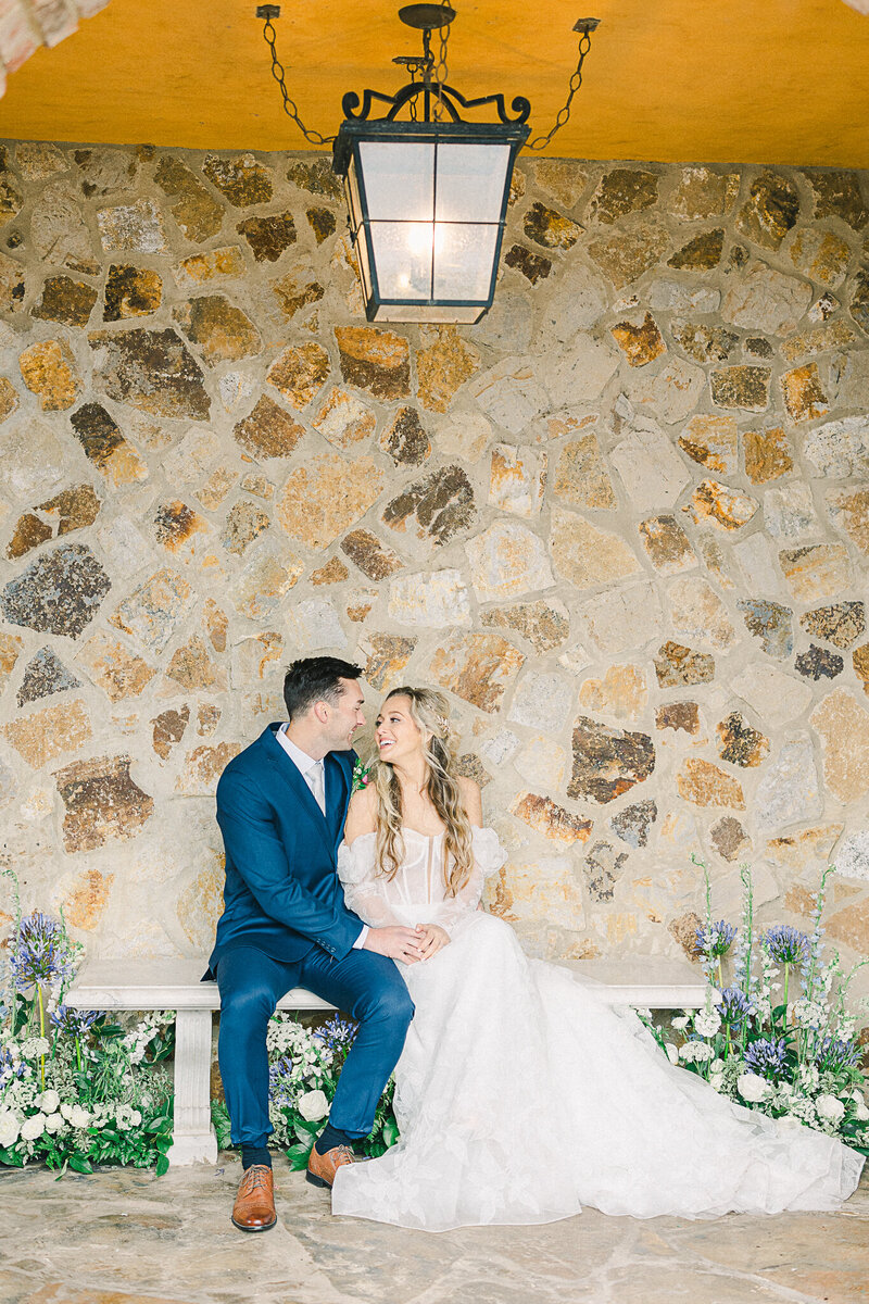Elegant wedding ceremony at Bella Collina in Montverde, Florida, featuring a bride and groom surrounded by Tuscan-inspired architecture, lush gardens, rolling hills, and picturesque lake views.
