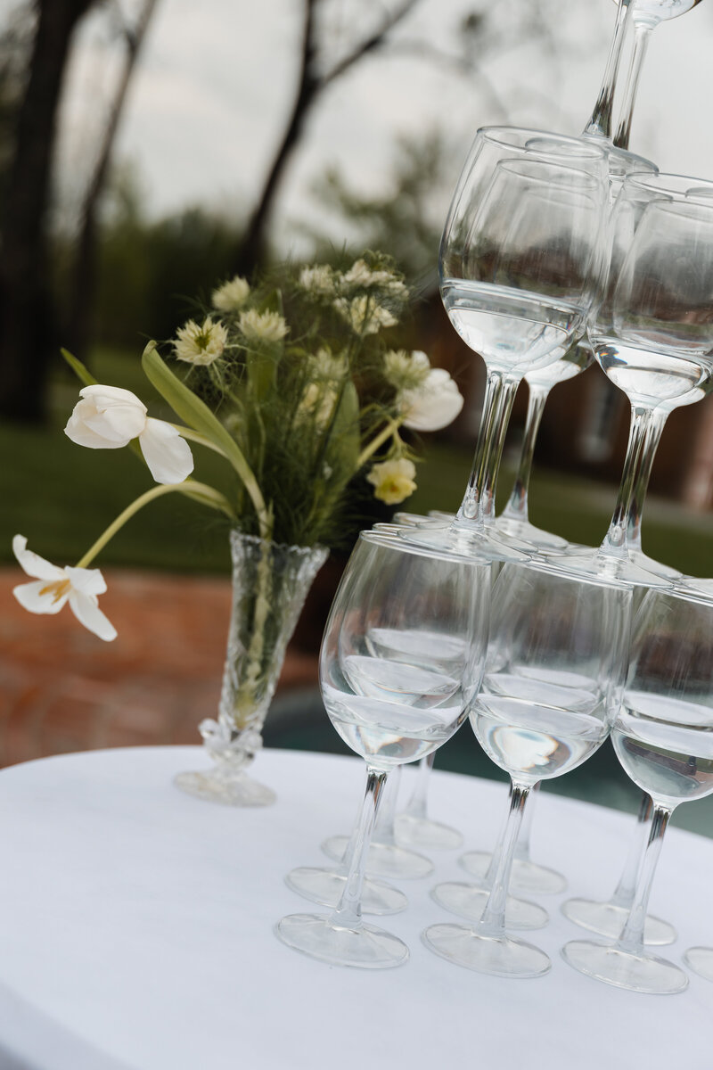 Close-up of a champagne tower at a wedding reception, capturing the sparkling glasses and celebratory atmosphere in an elegant detail shot.
