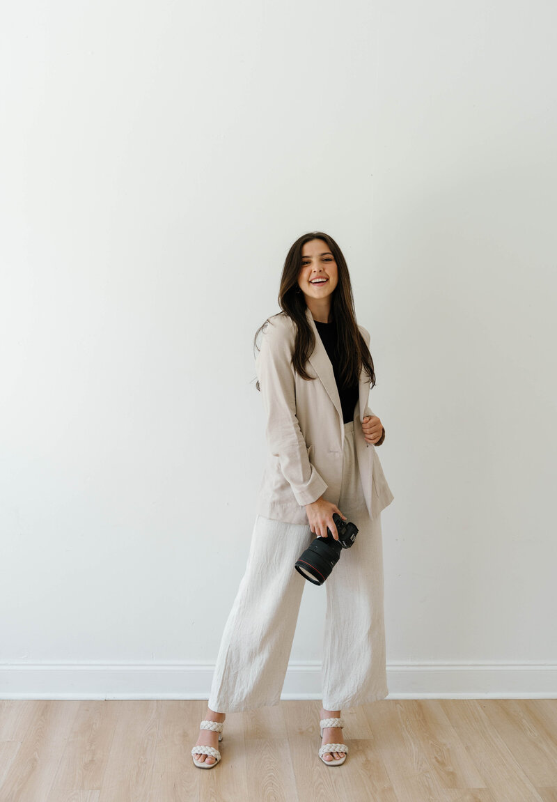 Reilly Erin holding her camera and smiling confidently.