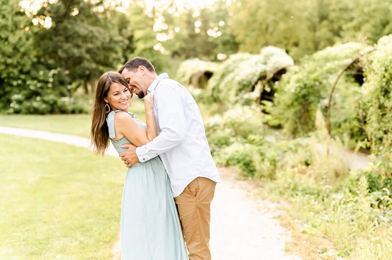 Husband and wife looking at each other lovingly during an in home family photography session near Naperville, IL.