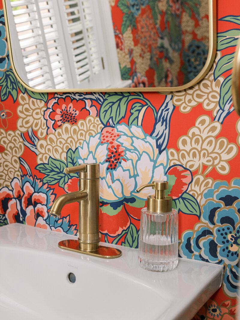 Floral red wallpaper with gold accents in a stunning powder room  in Old Town, Alexandria, VA.