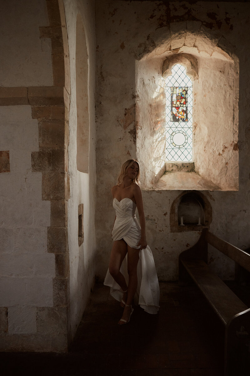 Handmade silk wedding dress, corset-style, long worn by bride in chapel