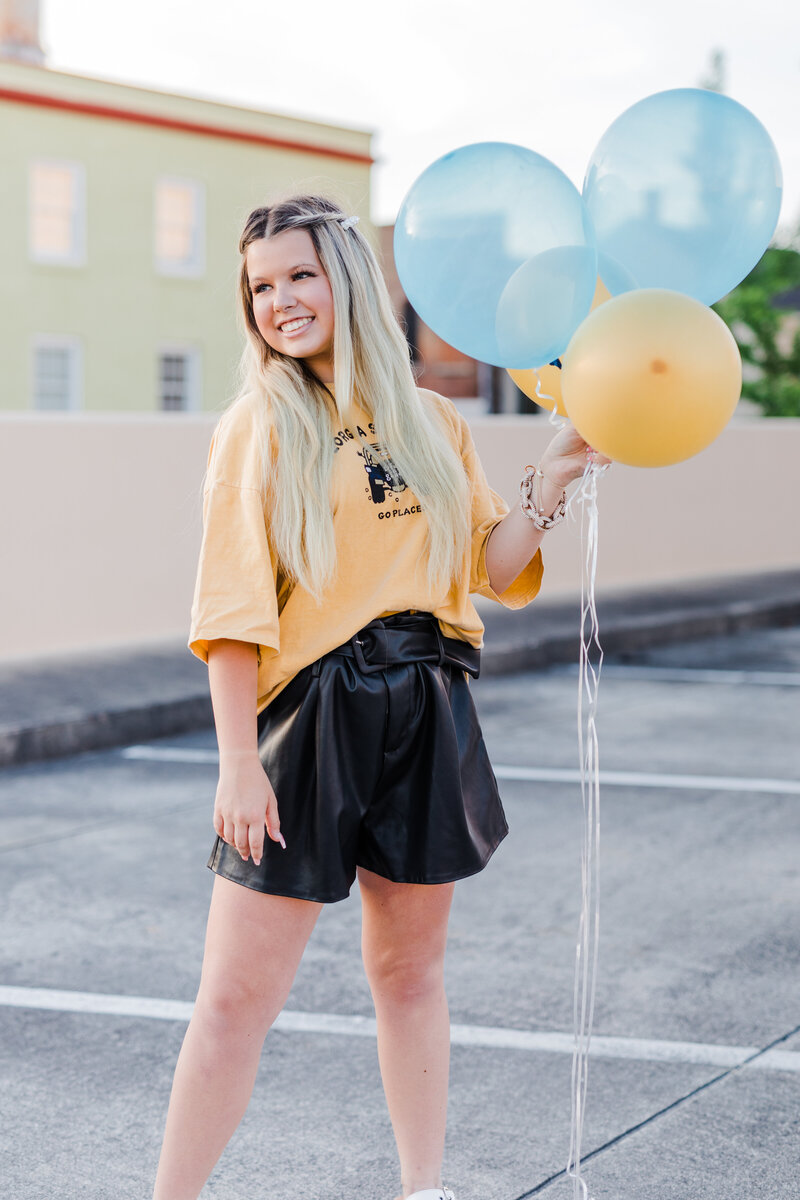 Spring graduation pictures in Georgia with girl holding balloons with Augusta senior photographer