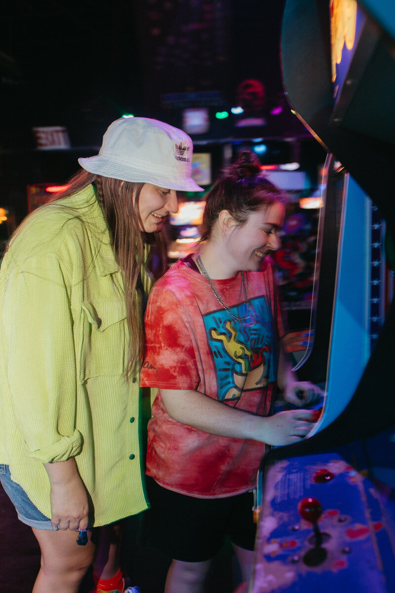 two girls playing an arcade game