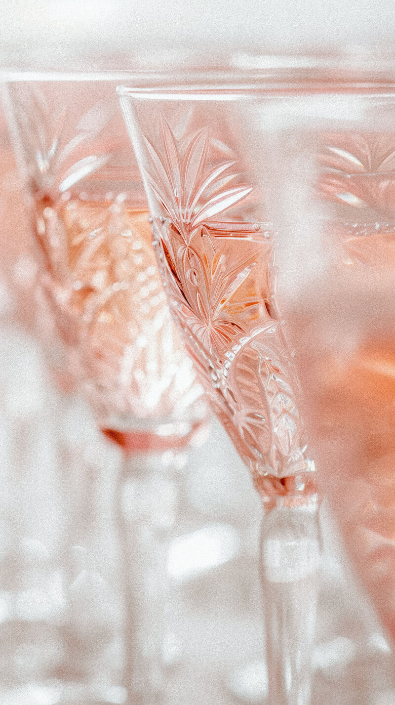 Fine crystal glasses filled with rosé representing the luxe and beautiful vendor services offered by bridal show vendors.