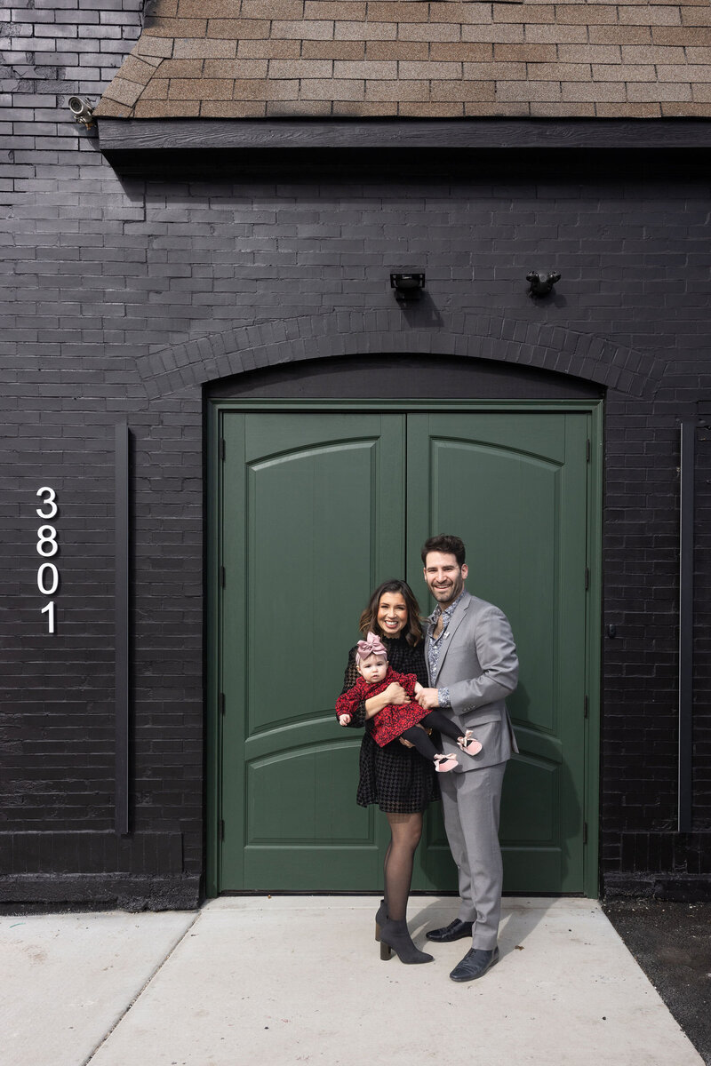 Edelcup family posed in front of official front door and guest entrance of space