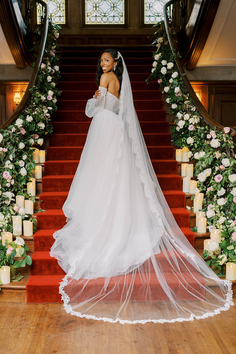 Black bride taking a bridal portrait on the staircase of Callanwolde