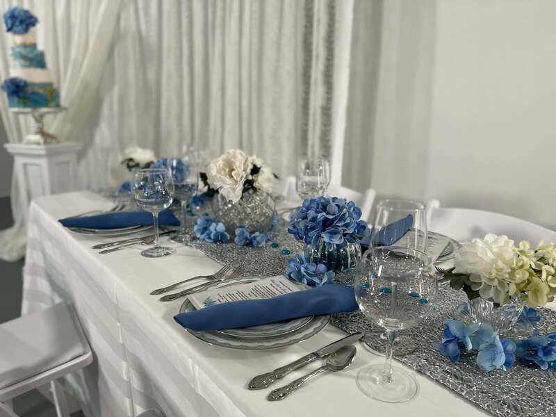 Blue and silver themed table setting at wedding