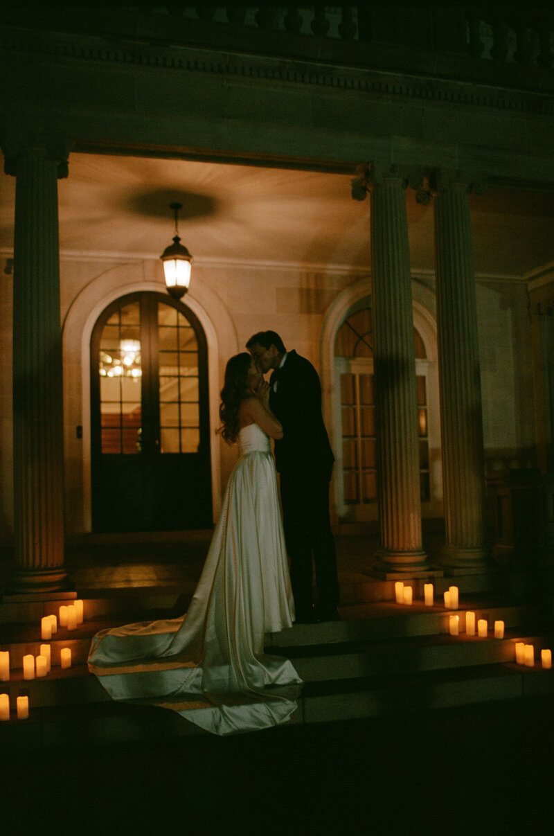 A couple shares a tender moment, their faces illuminated by the soft glow of sunset, evoking a sense of timeless romance.