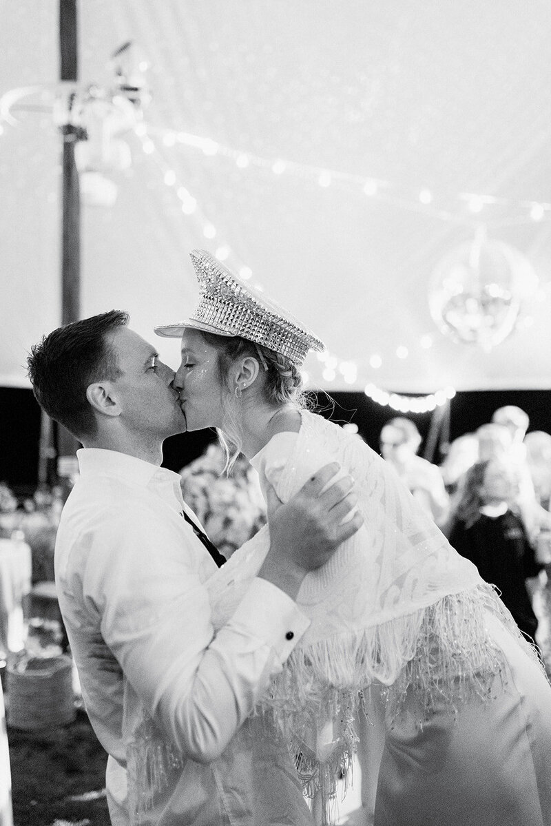 Bride and Groom kissing at wedding reception coordinated by Perfect Thirds & Co.
