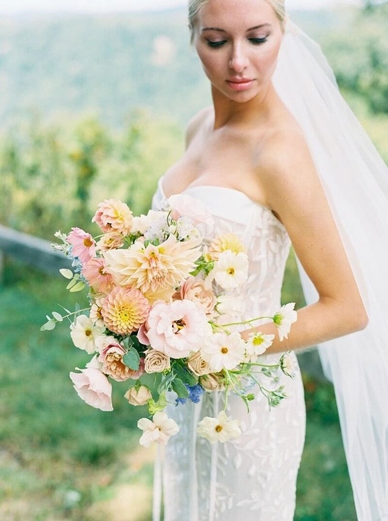 Stunning bride holds her wedding bouquet
