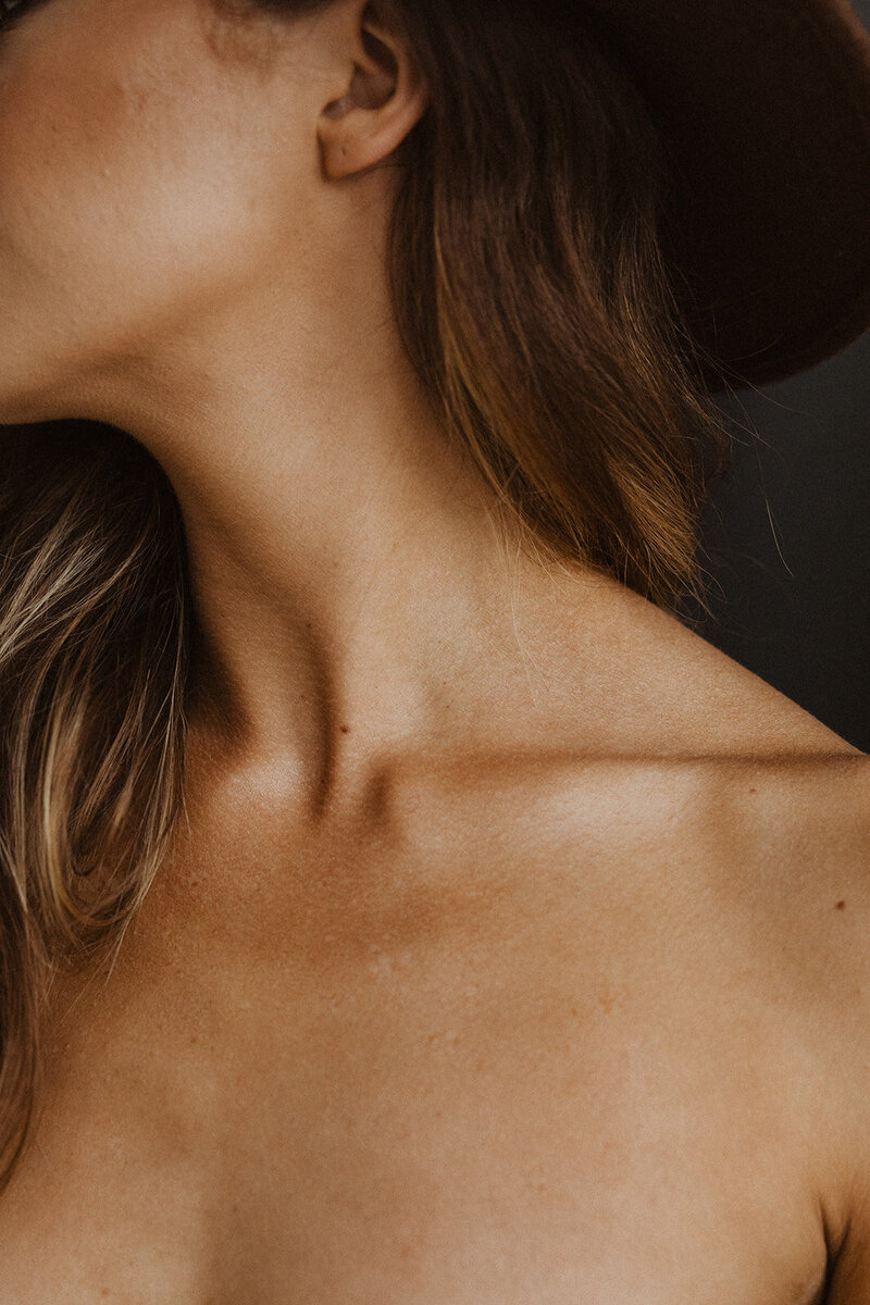 Woman bares her neck in Minnesota boudoir photography session