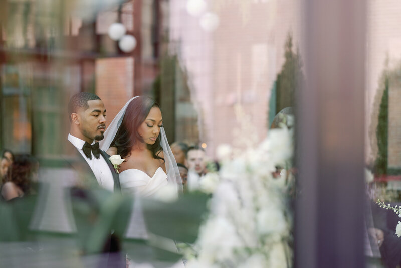 African American couple's wedding ceremony. Taken through the window of the Shinola hotel in Detroit. 