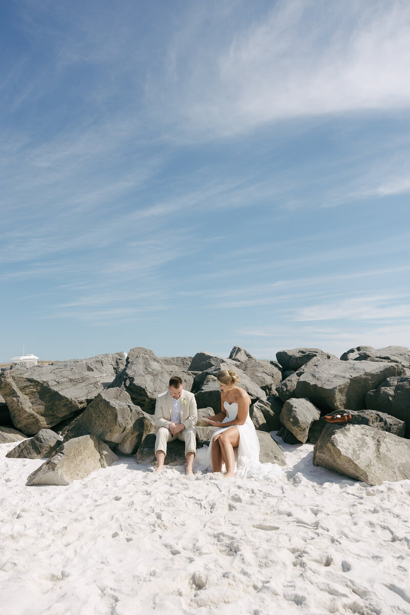 Bride and Groom climbing rocks in the 30A Florida