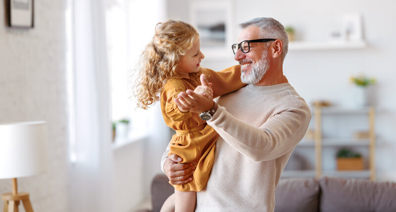 Older man dancing with young girl