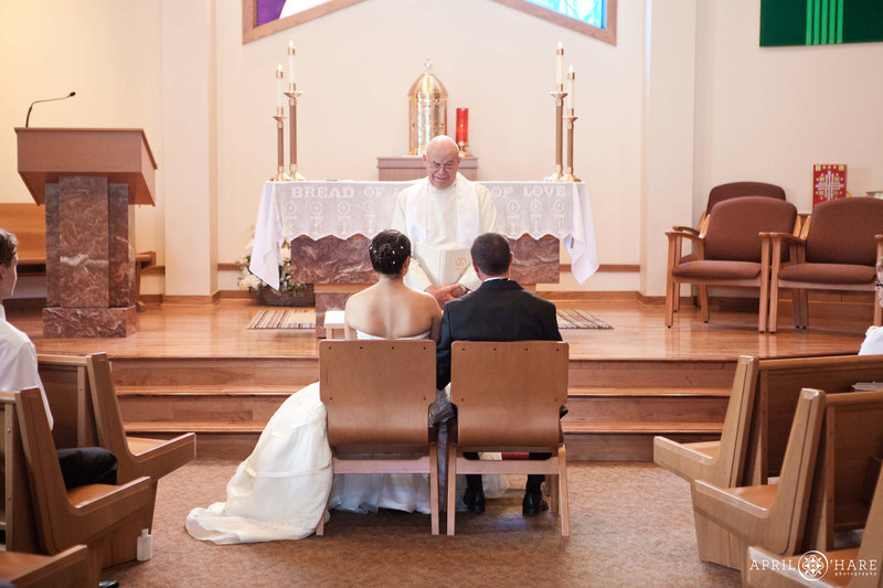 Couple sits at the front of Saint Mary's Catholic Church in Breckenridge Colorado