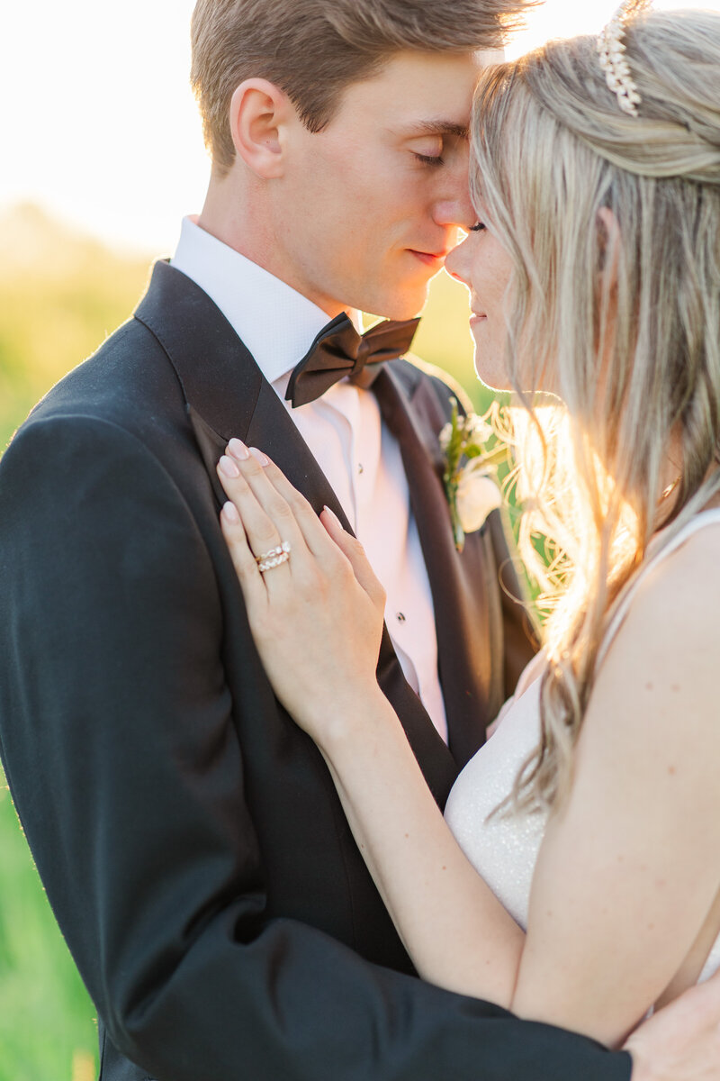 a bride with her hand on her groom's chest