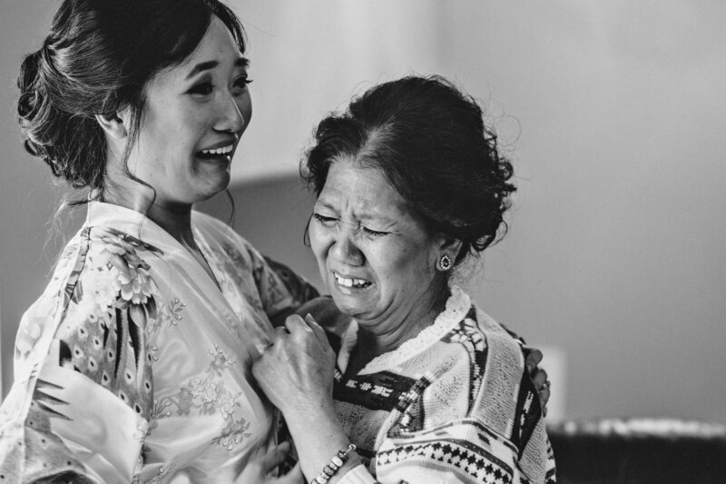 bride and her mother embracing and crying