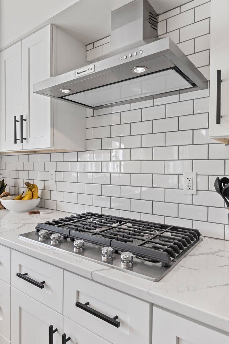 White kitchen backsplash above a stove range