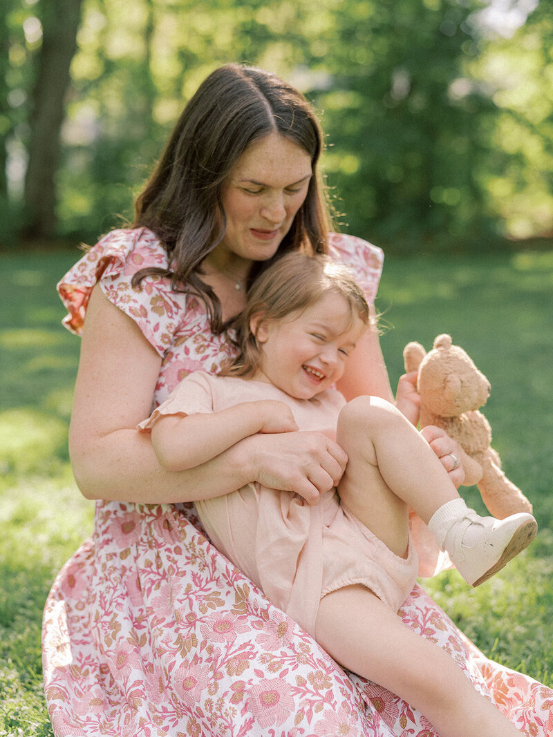 Mom tickling her little girl