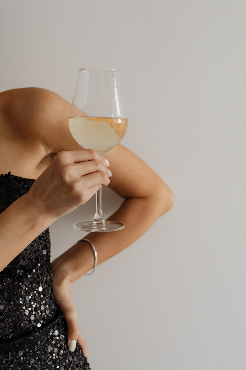 kaboompics_classy-aesthetics-beautiful-asian-woman-in-black-evening-dress-white-wine-in-a-glass-29503