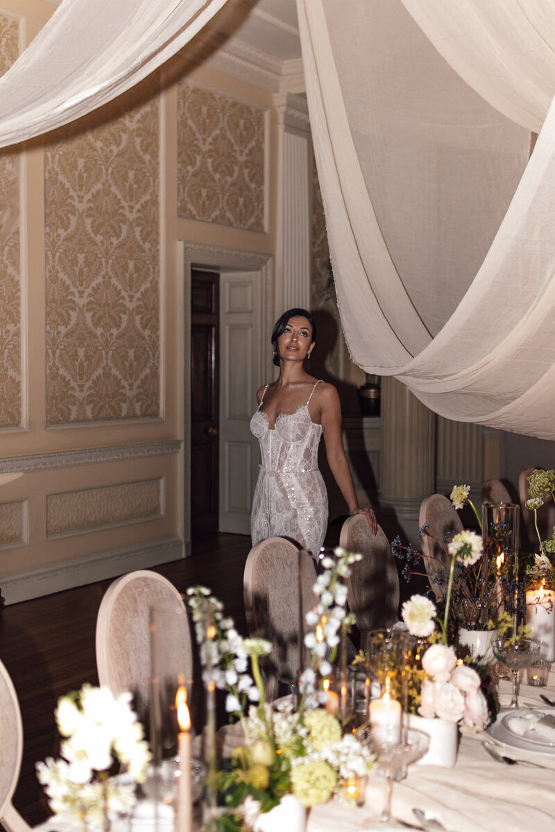 An emotional bride gets her veil attached whilst waiting to leave for her intimate central london wedding ceremony