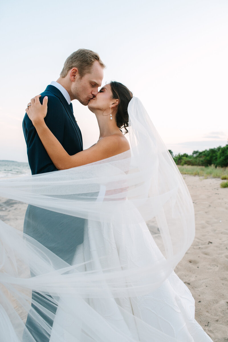 man holding his daughter who is wearing a white dress with a bow