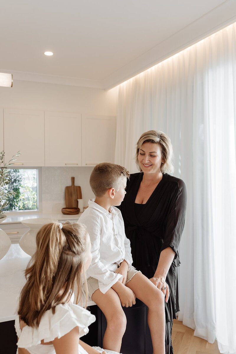 Lady standing with 2 children