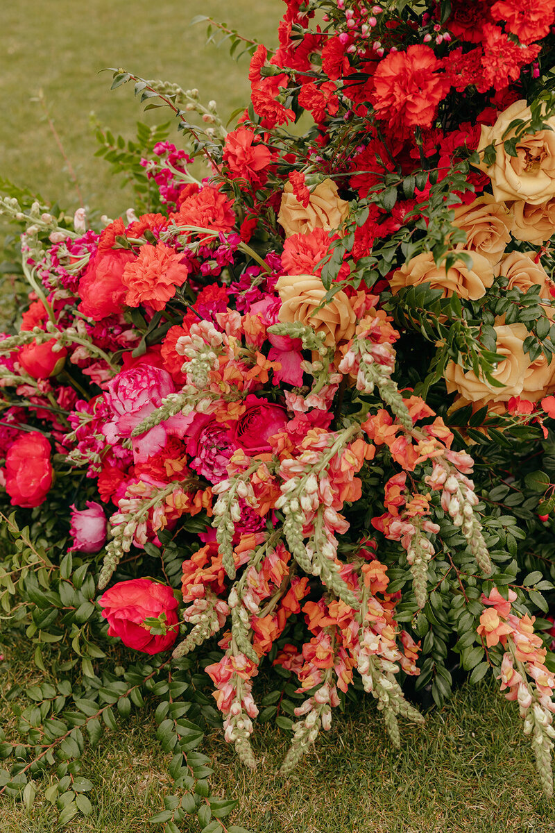 Colorful floral pillars at Brasada Ranch ceremony with mountain backdrop