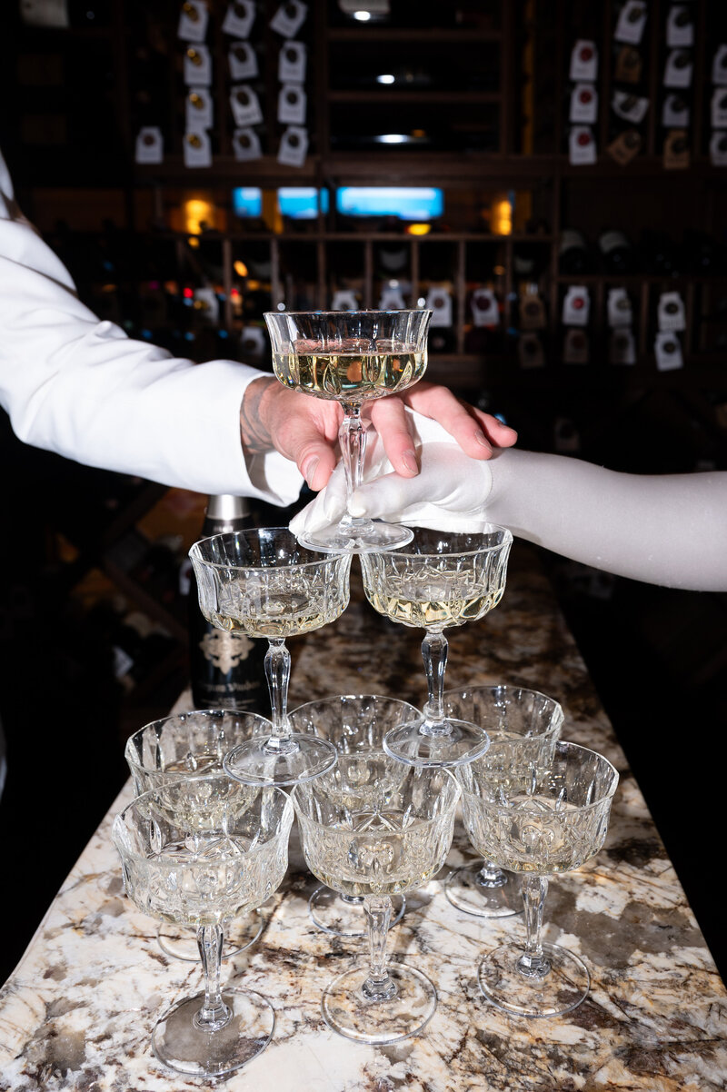 Pouring champagne near wedding cake