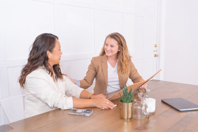 A female financial advisor consulting with her client in her office.