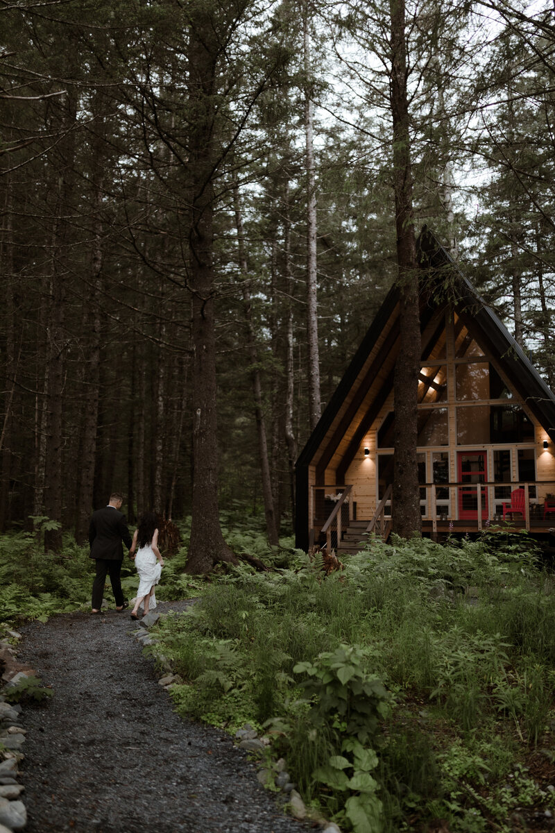 bride and groom near cabin