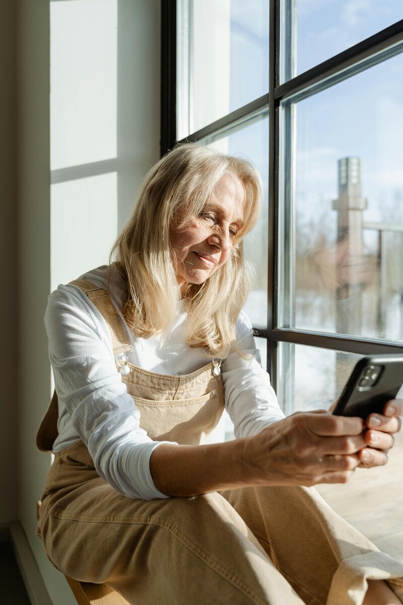 Older woman on phone scheduling an appointment