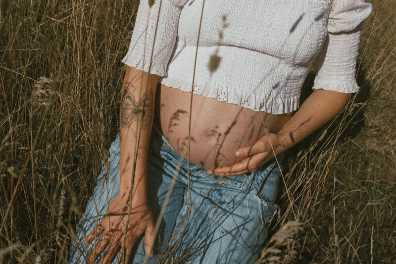 shadows on a pregnant mama belly during fernie maternity photo session.